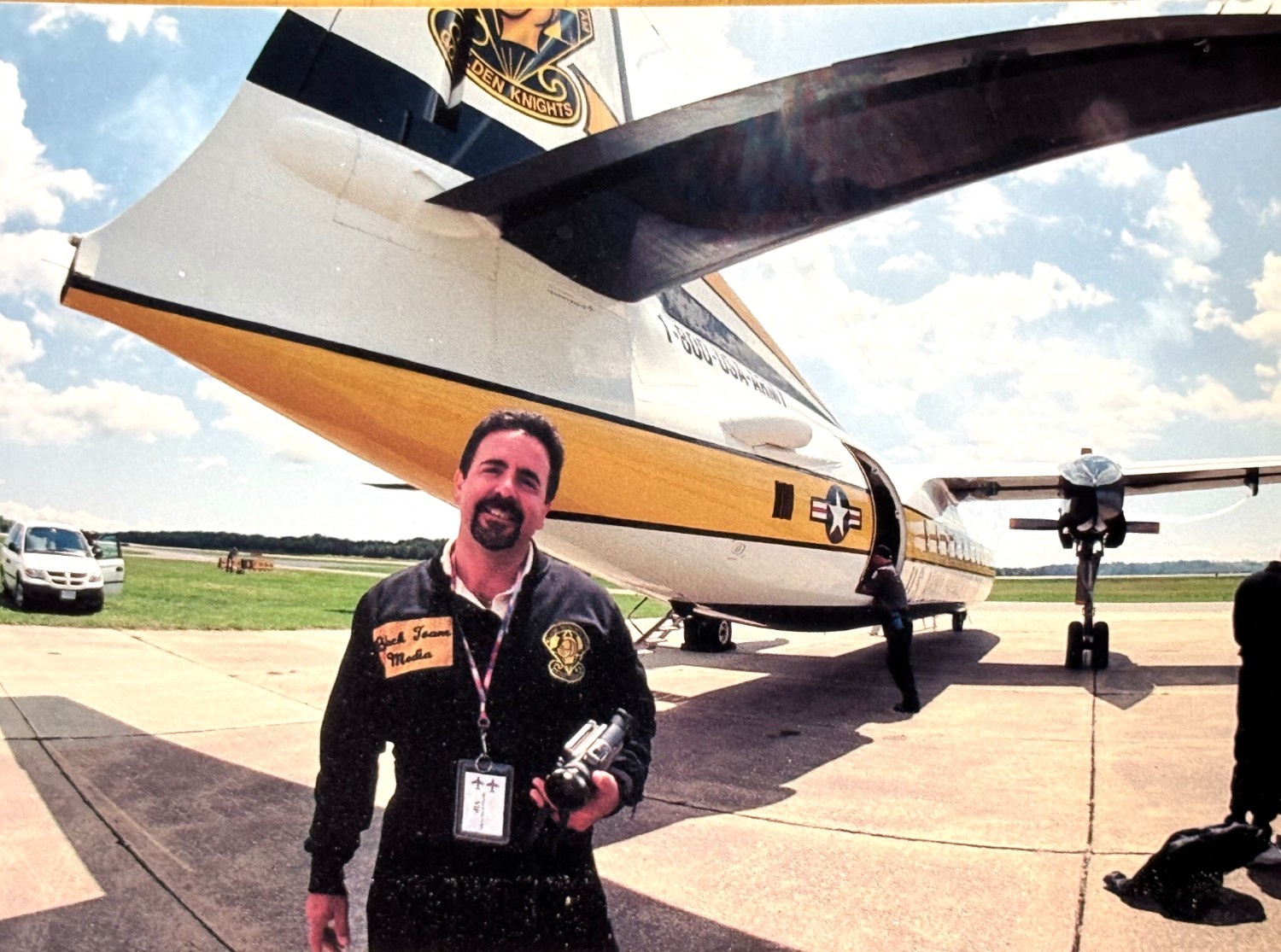 Tommy with a camera in front of an aircraft