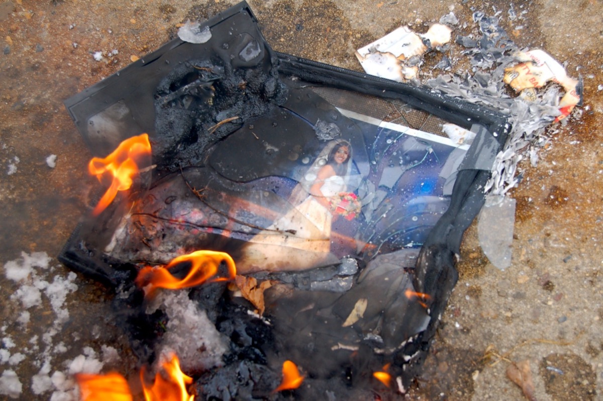 A framed family photo burning